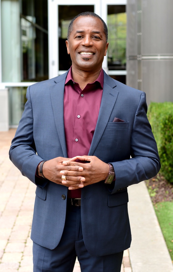Confident man in a suit, smiling and posing outdoors